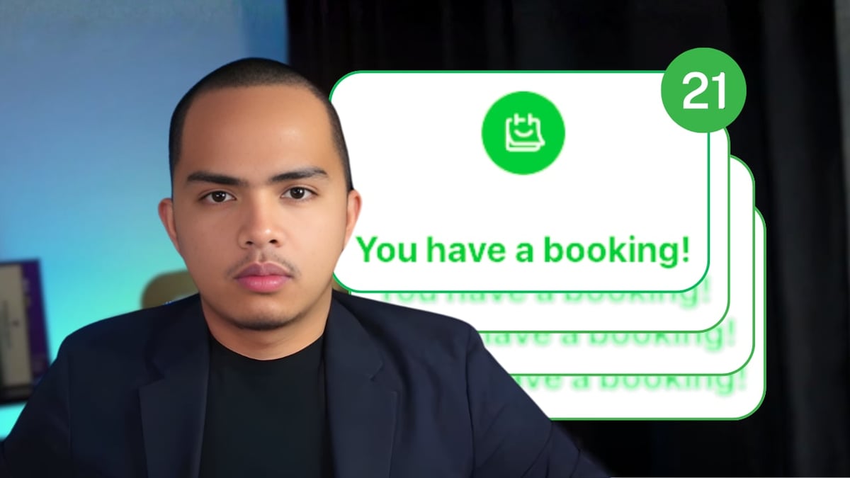Man in dark blazer with booking notification showing 21 pending bookings on screen behind him